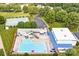 Aerial shot of community pool with slides, sun loungers, and a tennis court at 1515 Kingdom Way, Fort Mill, SC 29707