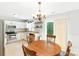 Bright dining area with a chandelier, a round table and stainless steel appliances in an open layout at 1515 Kingdom Way, Fort Mill, SC 29707