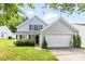 Charming two-story home with light blue siding, black shutters, and a well-manicured front yard at 1515 Kingdom Way, Fort Mill, SC 29707