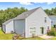 Rear exterior of the home featuring the yard, siding, patio, flowers, and partial fence at 1515 Kingdom Way, Fort Mill, SC 29707