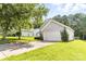 Features a well-maintained lawn and a two-car garage, complemented by lush greenery at 1515 Kingdom Way, Fort Mill, SC 29707