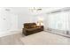 Inviting living room featuring a plush brown sofa, ample natural light, and neutral-toned flooring at 1515 Kingdom Way, Fort Mill, SC 29707