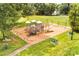 Aerial view of the community playground with swings, picnic tables and mature trees at 1515 Kingdom Way, Fort Mill, SC 29707