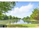Scenic pond view with fountain, surrounded by lush trees, offering a serene atmosphere at 1515 Kingdom Way, Fort Mill, SC 29707