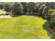 Overhead view of a lush green soccer field with goals and well-maintained grass, surrounded by trees and a playground at 1515 Kingdom Way, Fort Mill, SC 29707