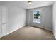 Bright bedroom boasts a window and neutral-toned carpet, providing calm and warmth at 1523 Merrie Meadow Ct, Rock Hill, SC 29732