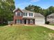 Charming two-story home with brick and vinyl facade, a two-car garage, and a well-maintained lawn at 1523 Merrie Meadow Ct, Rock Hill, SC 29732