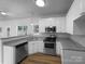 Modern kitchen featuring stainless steel appliances, granite countertops, and wood-look flooring at 1523 Merrie Meadow Ct, Rock Hill, SC 29732