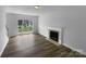 Bright living room with a fireplace, wood flooring, and a large window at 1523 Merrie Meadow Ct, Rock Hill, SC 29732