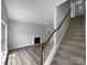 Open living room boasts wood-look floors, fireplace, and staircase to the upper level at 1523 Merrie Meadow Ct, Rock Hill, SC 29732