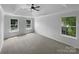 Spacious main bedroom features carpet, a tray ceiling, and two windows at 1523 Merrie Meadow Ct, Rock Hill, SC 29732
