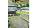 Relaxing back porch with white railing overlooking a spacious backyard with a white fence at 1700 Pickwick Ave, Kannapolis, NC 28083