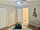 Bedroom with ceiling fan and view into bathroom at 1700 Pickwick Ave, Kannapolis, NC 28083