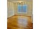 Sunny dining room with hardwood floors, large window, and classic trim detail at 1700 Pickwick Ave, Kannapolis, NC 28083