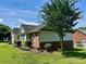 Charming one-story home featuring a well-maintained lawn and mature landscaping at 1700 Pickwick Ave, Kannapolis, NC 28083