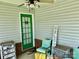 Welcoming front porch with a vibrant green door, cozy seating, and decorative welcome sign at 1700 Pickwick Ave, Kannapolis, NC 28083