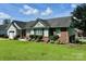 Well-kept one-story home with brick and siding, lush landscaping, and a green lawn at 1700 Pickwick Ave, Kannapolis, NC 28083