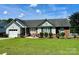 Inviting one-story home with manicured lawn, brick facade, and black shuttered windows at 1700 Pickwick Ave, Kannapolis, NC 28083