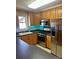 Well-lit kitchen featuring stainless steel appliances, wood cabinets, and sleek countertops at 1700 Pickwick Ave, Kannapolis, NC 28083