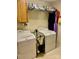 Functional laundry room features washer, dryer, storage cabinets, and tile floor at 1700 Pickwick Ave, Kannapolis, NC 28083