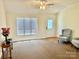 Bright living room with plush carpeting, neutral walls, and plenty of natural light at 1700 Pickwick Ave, Kannapolis, NC 28083
