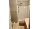 A clean white shower stall with a shower head, shelving unit, and door leading to the toilet and vanity at 1700 Pickwick Ave, Kannapolis, NC 28083