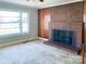 Cozy living room with a classic brick fireplace and ample natural light at 176 Travis Loop, Statesville, NC 28625