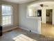 Open-concept living area with a window, archway, and access to kitchen at 176 Travis Loop, Statesville, NC 28625