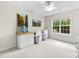Bright bedroom featuring white walls, a large window, and a built-in desk with two bar stools at 18522 Victoria Bay Dr, Cornelius, NC 28031