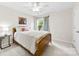 Cozy bedroom with a wood-framed bed, a patterned curtain, and natural light from the window at 18522 Victoria Bay Dr, Cornelius, NC 28031