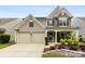 Attractive two-story home with a two-car garage, stone accents, and a covered front porch at 18522 Victoria Bay Dr, Cornelius, NC 28031