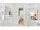 Hallway leading to a bathroom and bedroom with white railings and neutral carpeting at 18522 Victoria Bay Dr, Cornelius, NC 28031