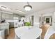 Charming kitchen with sage green cabinets, white appliances and wood flooring at 18522 Victoria Bay Dr, Cornelius, NC 28031