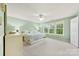 Airy main bedroom with mint green walls, neutral carpet and three windows overlooking a lush yard at 18522 Victoria Bay Dr, Cornelius, NC 28031