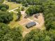 An aerial shot showcases the property with sprawling lawn and fencing, situated amongst mature trees at 2007 Sugar Hill Rd, York, SC 29745