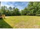 Expansive backyard featuring a mix of grassy and dry areas with natural tree line at 2007 Sugar Hill Rd, York, SC 29745