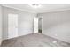 Neutral bedroom with gray walls, gray carpet, and two closets at 2007 Sugar Hill Rd, York, SC 29745