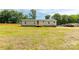 Spacious yard and exterior view of the light-colored home with wooden stairs at 2007 Sugar Hill Rd, York, SC 29745