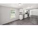 Bright eat-in kitchen featuring a window, stainless appliances, granite countertops, and white cabinetry at 2007 Sugar Hill Rd, York, SC 29745