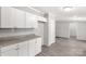 Eat-in kitchen featuring white cabinets, granite countertops, and gray laminate flooring at 2007 Sugar Hill Rd, York, SC 29745