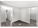 Neutral room with gray walls, laminate flooring, and multiple doorways at 2007 Sugar Hill Rd, York, SC 29745