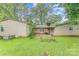 Backyard view with lush green grass and a partial view of the home's exterior at 203 Ewing Dr, Belmont, NC 28012