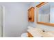 Bathroom with light blue walls, a tile shower, and single sink vanity with storage cabinet at 203 Ewing Dr, Belmont, NC 28012