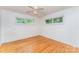 Cozy bedroom with hardwood floors, ceiling fan, and natural light from two windows at 203 Ewing Dr, Belmont, NC 28012