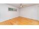 Bright bedroom with hardwood floors, ceiling fan, and a large window at 203 Ewing Dr, Belmont, NC 28012
