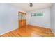 Bedroom with hardwood floors, built-in closet, and window with leafy view at 203 Ewing Dr, Belmont, NC 28012