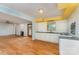 Open floor plan with hardwood floors connecting kitchen and living room with neutral color palette at 203 Ewing Dr, Belmont, NC 28012