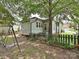 View of backyard with a swing set, fencing, and a green vinyl-sided home exterior at 214 Tenth St, Cramerton, NC 28032
