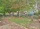 Backyard area with wood privacy fence, mature trees, play set, and patio area at 214 Tenth St, Cramerton, NC 28032