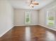 Bedroom with hardwood floors, neutral walls, white trim, ceiling fan, and natural light at 214 Tenth St, Cramerton, NC 28032